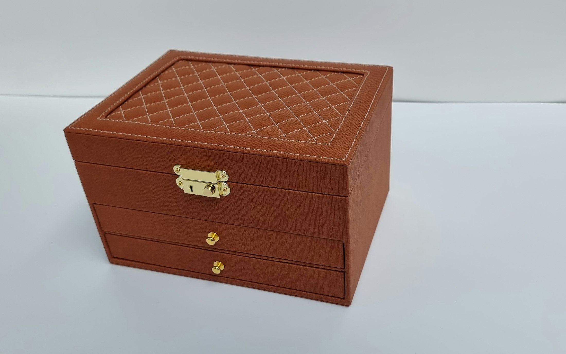 A tan leather jewellery box with brass clasp