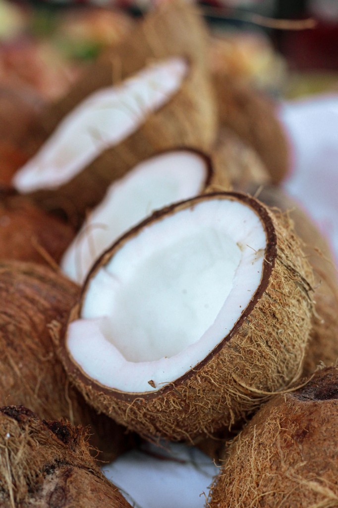 A halved coconut among whole coconuts